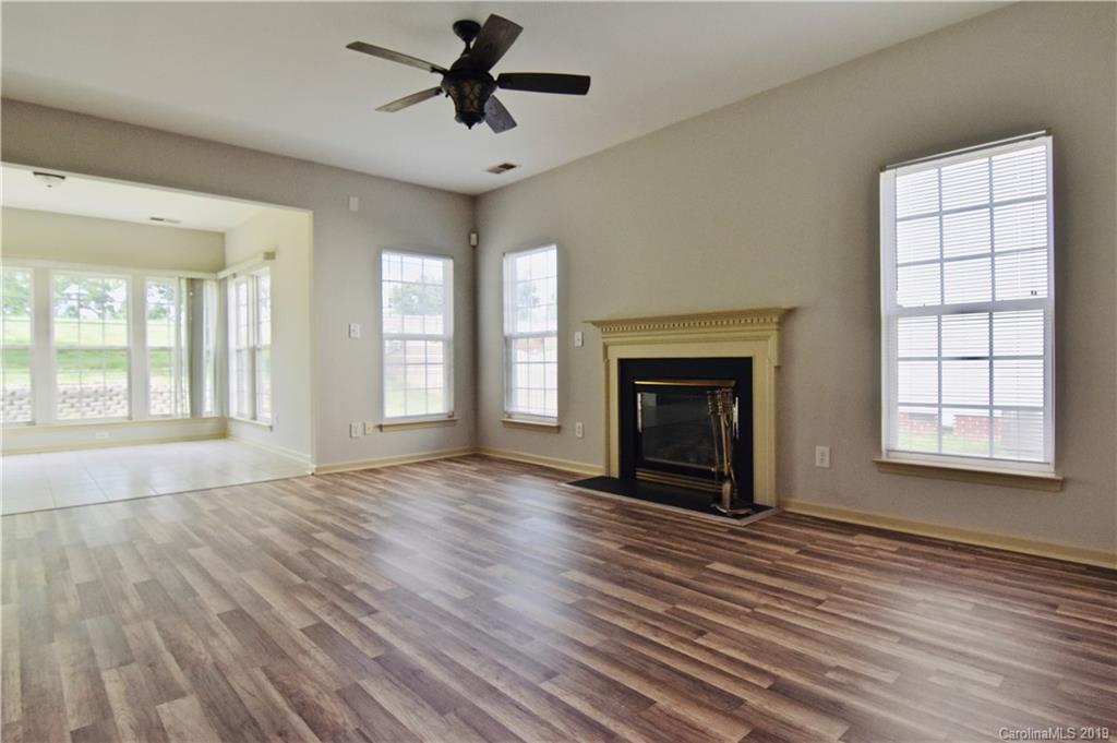 509 Circle Trace Road Monroe, NC 28110 - Photo 17 of 36 wooden floor fireplace and windows in an empty room