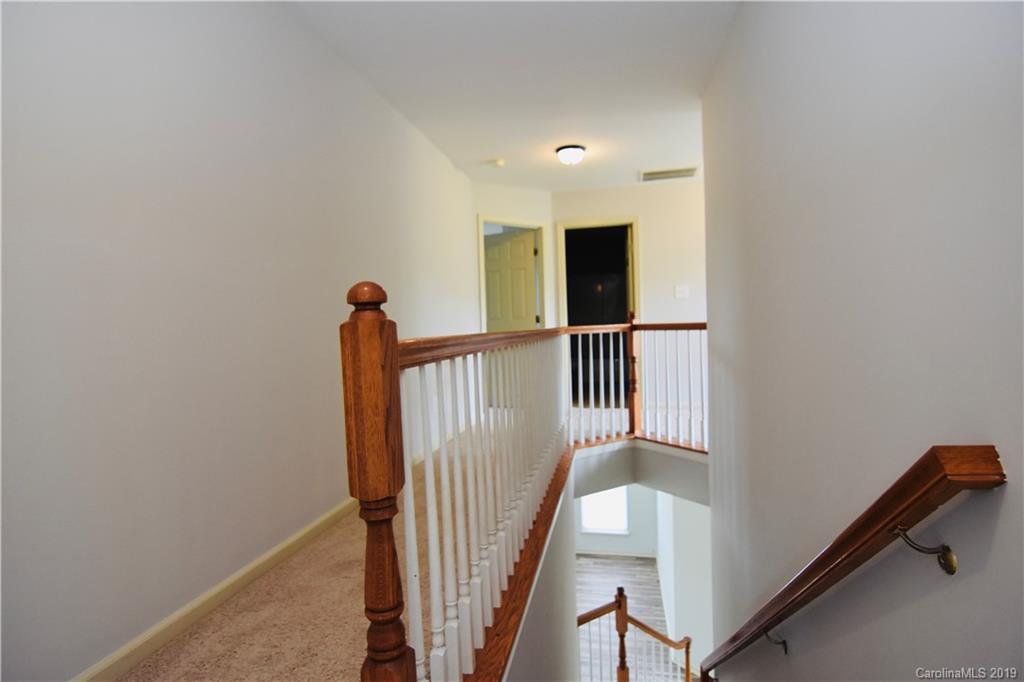 509 Circle Trace Road Monroe, NC 28110 - Photo 19 of 36 a view of a hallway with a white door and wooden floor