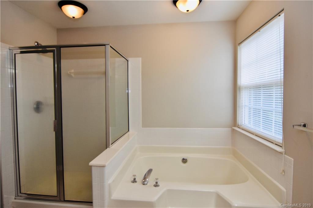509 Circle Trace Road Monroe, NC 28110 - Photo 23 of 36 a bathroom with a tub and shower