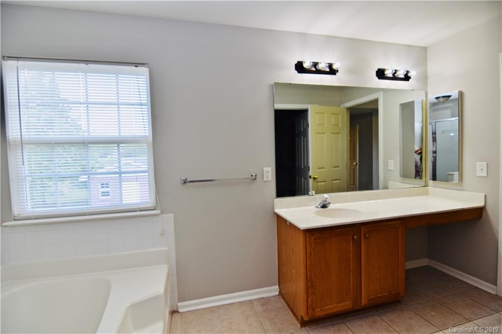 509 Circle Trace Road Monroe, NC 28110 - Photo 24 of 36 a bathroom with a sink a mirror and a window