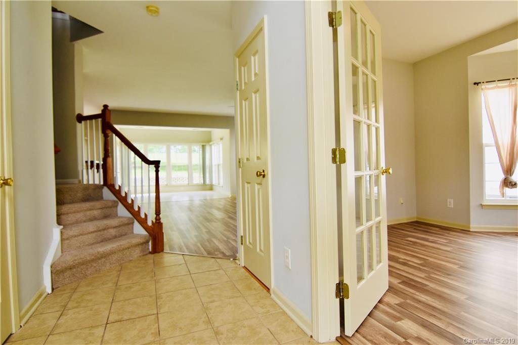 509 Circle Trace Road Monroe, NC 28110 - Photo 4 of 36 a view of a hallway with wooden floor and staircase