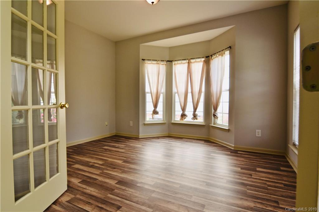 509 Circle Trace Road Monroe, NC 28110 - Photo 5 of 36 a view of an empty room with wooden floor and a window