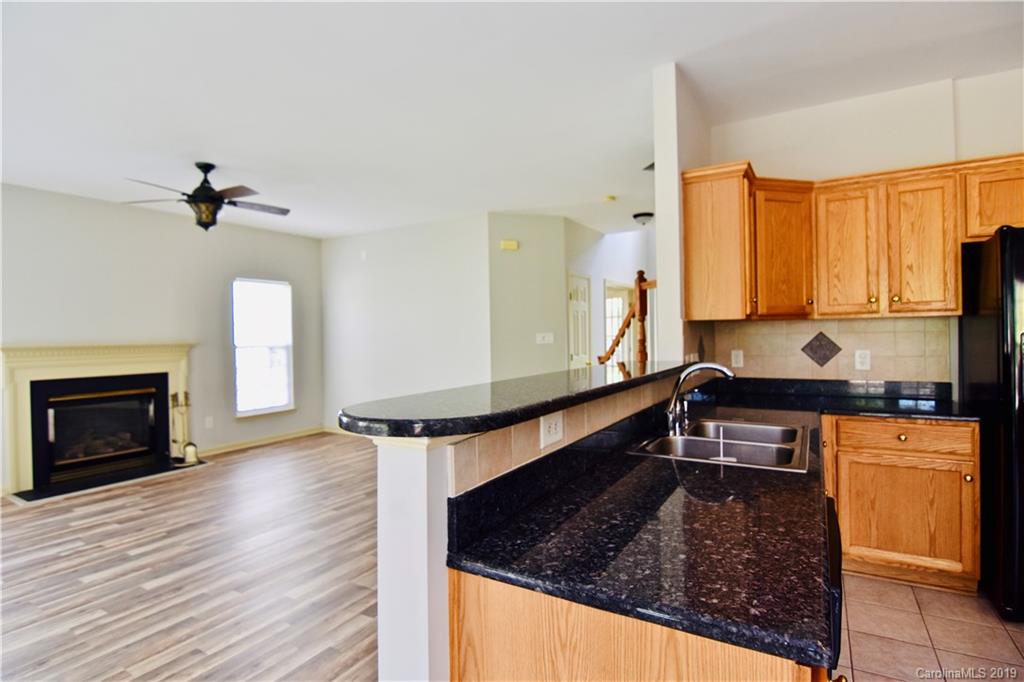 509 Circle Trace Road Monroe, NC 28110 - Photo 10 of 36 a kitchen with stainless steel appliances granite countertop a stove a sink and a microwave