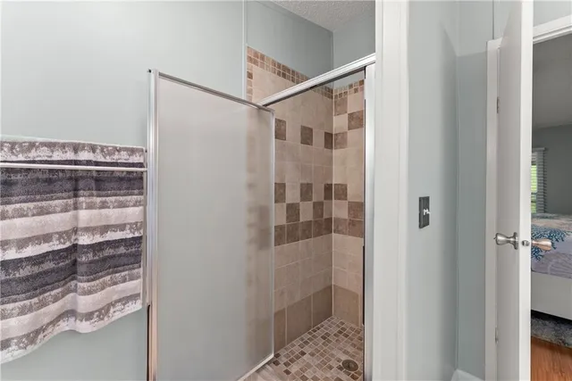 a bathroom with a glass shower door