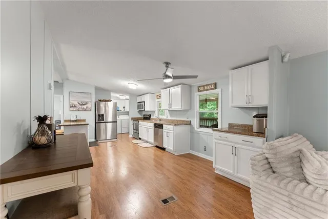 a kitchen with white cabinets and white appliances