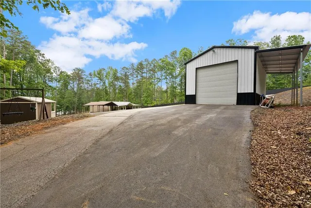 a backyard of a house with table and chairs in front of it