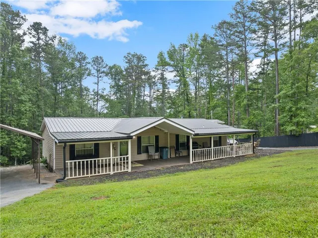 a view of a house with a backyard and porch