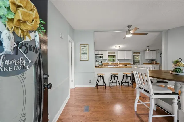 a view of a dining room with furniture and a chandelier