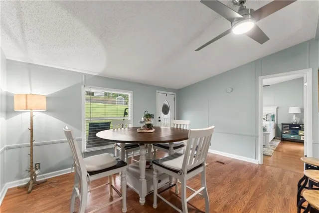 a view of a dining room with furniture and wooden floor