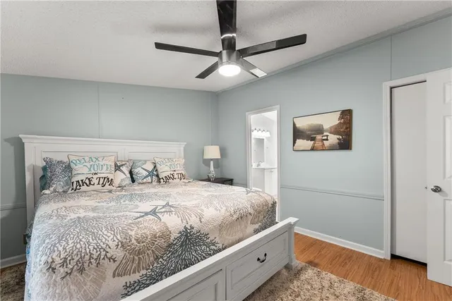 a bedroom with a large bed and a chandelier