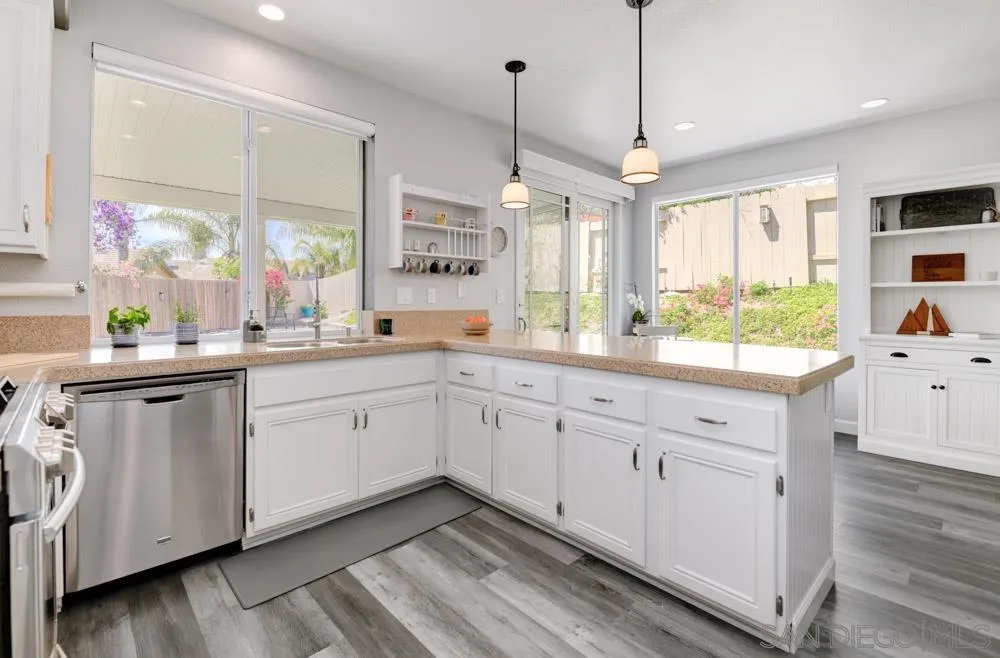 963 Martinique Drive Chula Vista, CA 91913 - Photo 12 of 37 a kitchen with white cabinets and window