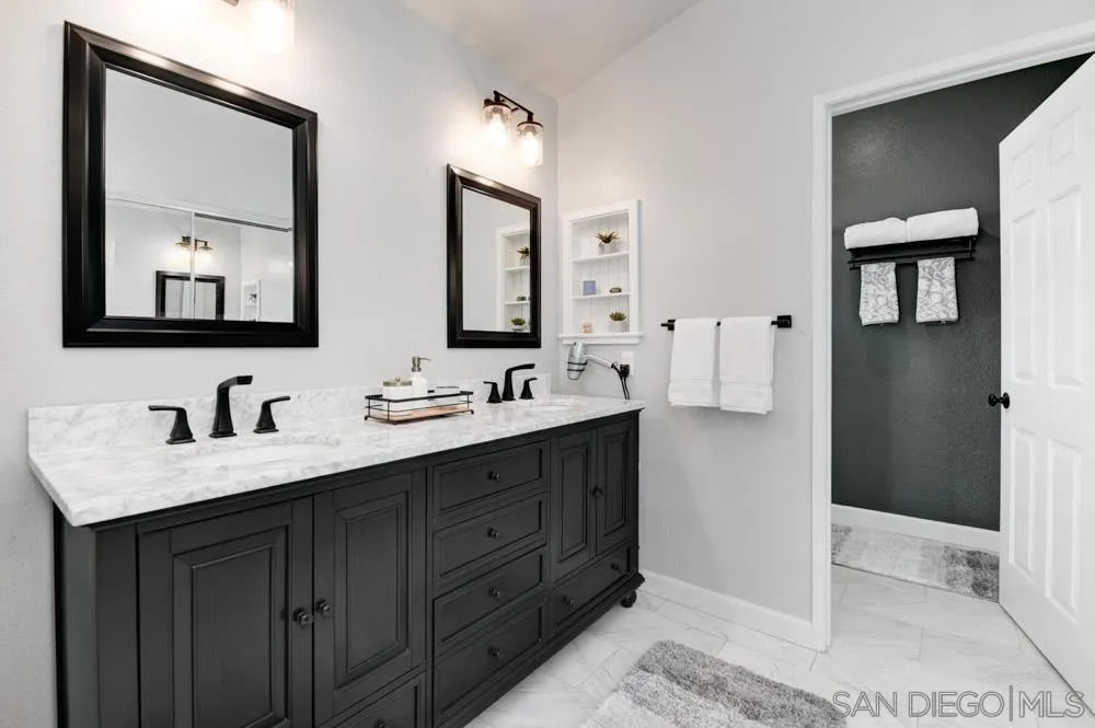 963 Martinique Drive Chula Vista, CA 91913 - Photo 21 of 37 a bathroom with a sink vanity and mirror