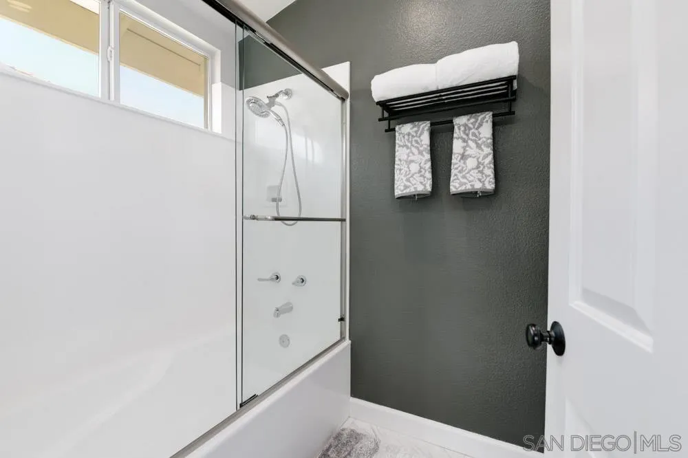 963 Martinique Drive Chula Vista, CA 91913 - Photo 22 of 37 a bathroom with a white cabinet and a shower
