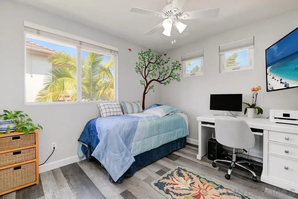 963 Martinique Drive Chula Vista, CA 91913 - Photo 24 of 37 a bedroom with a bed table chair and a window