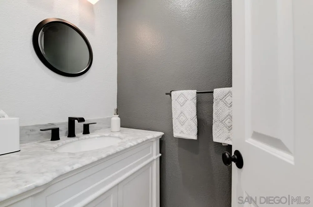 963 Martinique Drive Chula Vista, CA 91913 - Photo 26 of 37 a bathroom with a sink and a mirror