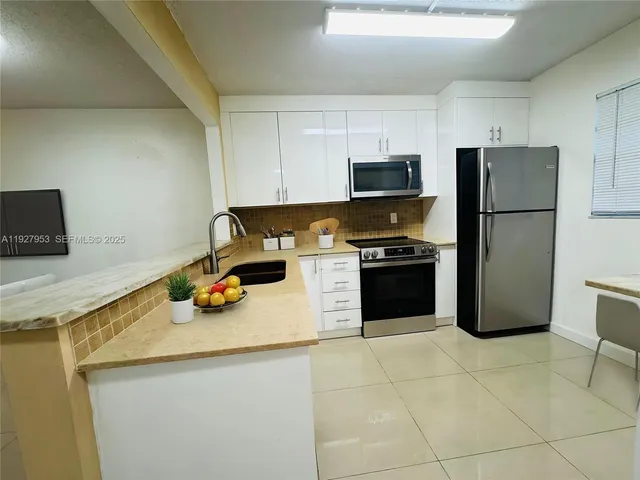 a kitchen with a sink a stove and refrigerator