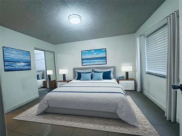 a bedroom with a bed and a wall painting