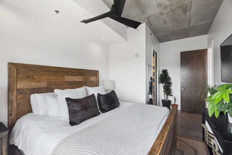 a bedroom with a bed and a potted plant