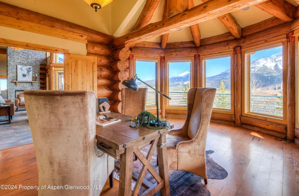 a dining room with furniture and wooden floor