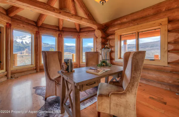 a living room with furniture a dining table and a table with wooden floor