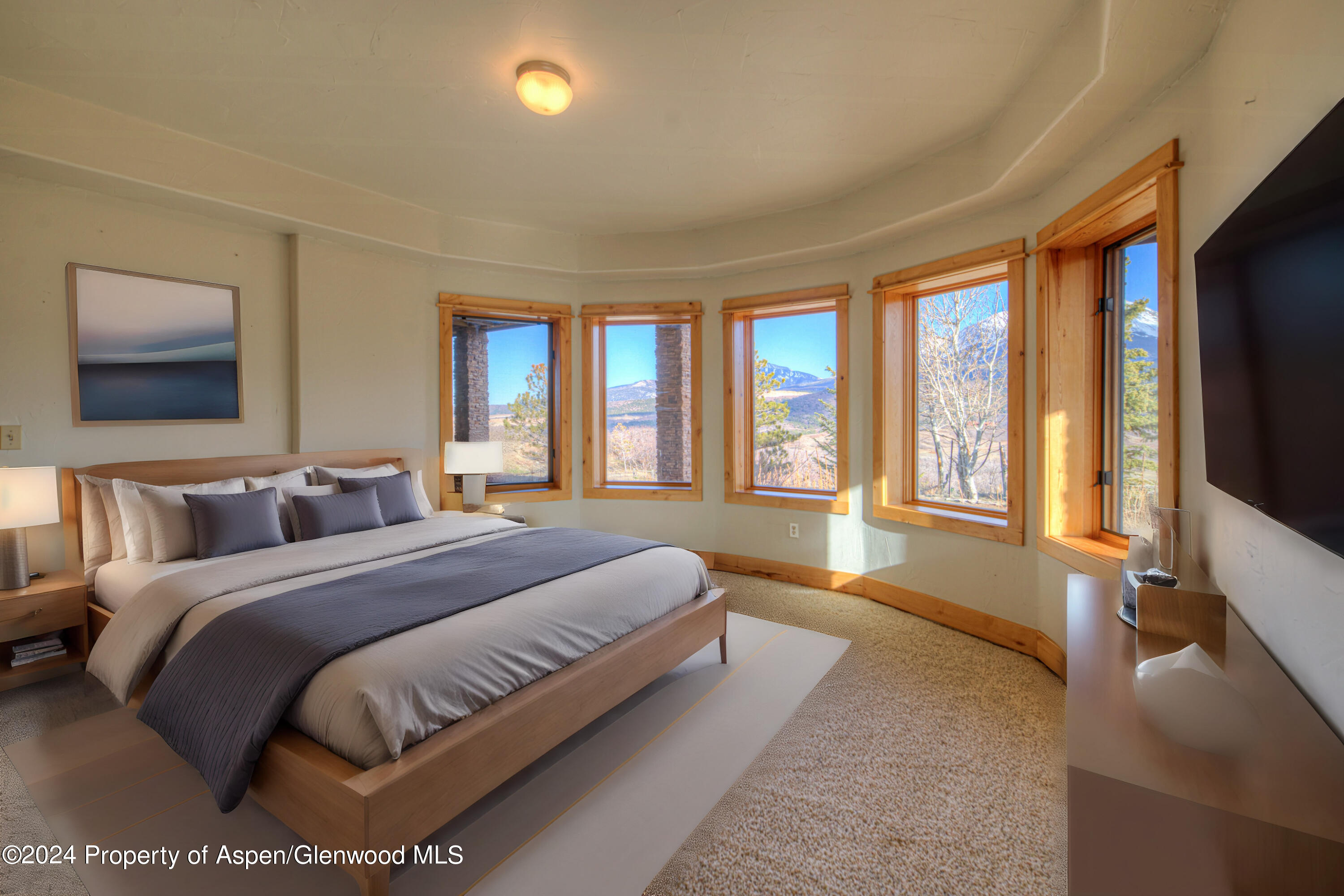 1390 Mountain Valley Road La Veta, CO 81055 - Photo 31 of 43 a spacious bedroom with a large bed and a flat tv screen on dresser