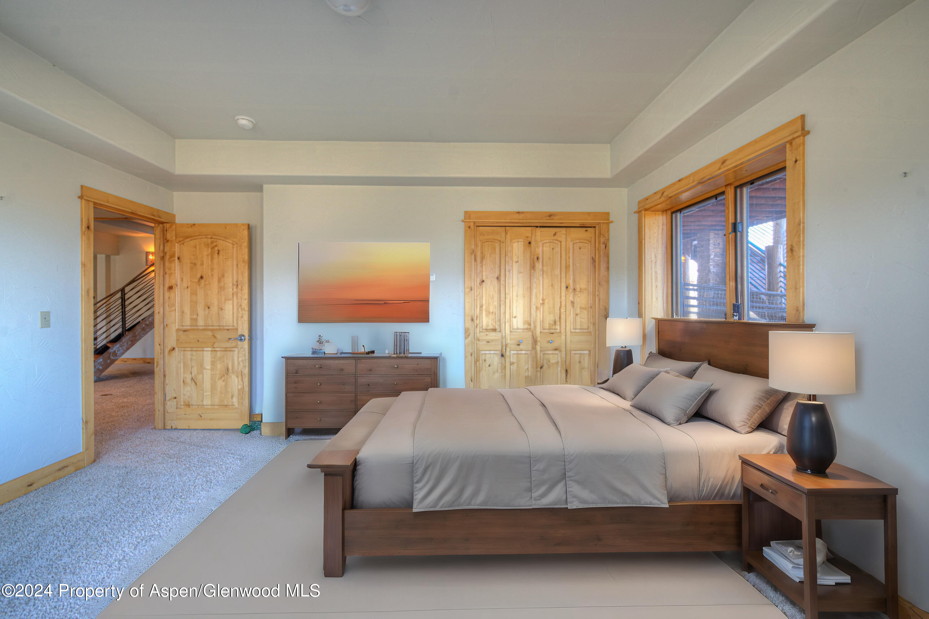 1390 Mountain Valley Road La Veta, CO 81055 - Photo 32 of 43 a bedroom with a large bed and a lamp