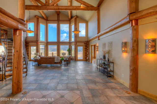 a living room with furniture a lamp and a potted plant
