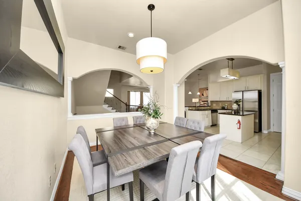 a view of a dining room with furniture and a chandelier