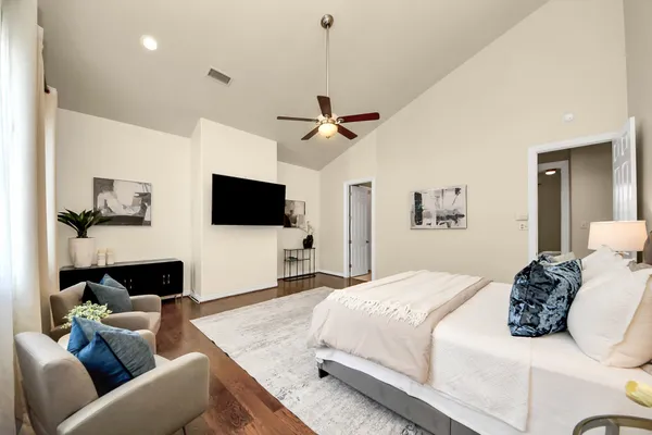 a bedroom with a bed couch and a window