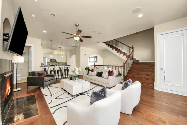 a living room with fireplace furniture and a flat screen tv