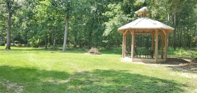 a view of a house with a yard and sitting area