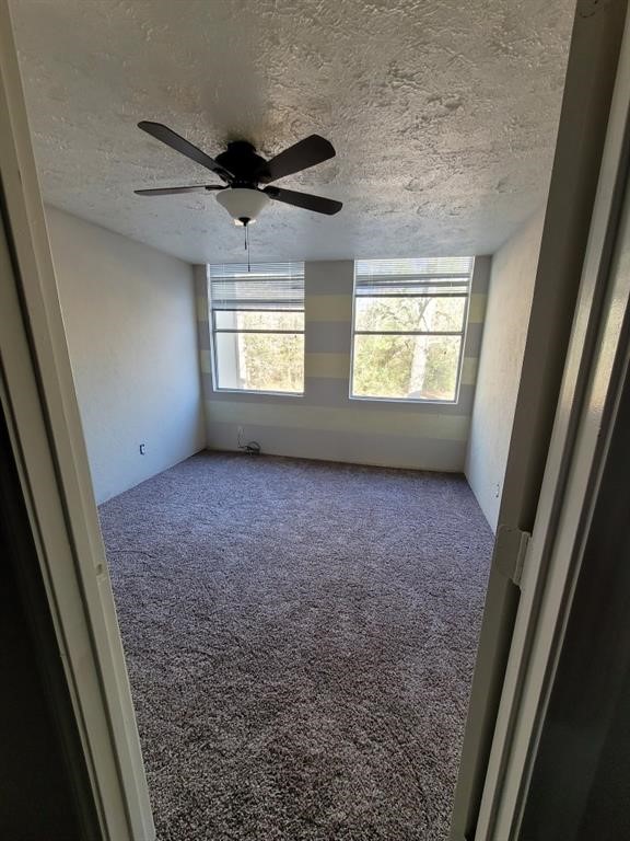 28 Lakeway Street Conroe, TX 77304 - Photo 5 of 9 a view of room with window and a ceiling fan