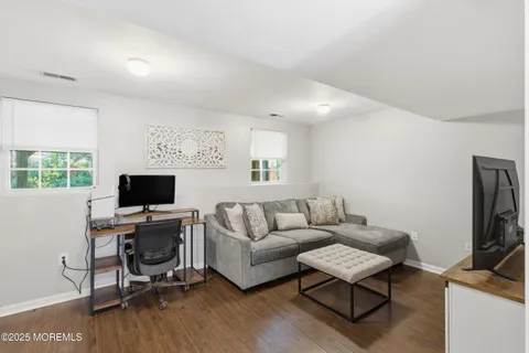 a living room with furniture a rug and a flat screen tv