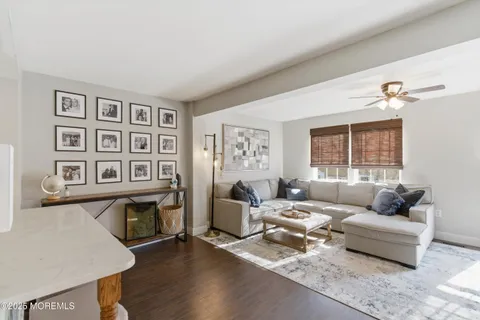 a living room with furniture and paintings on the wall