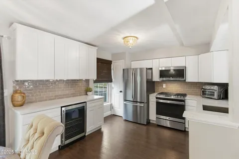 a kitchen with stainless steel appliances a stove sink and refrigerator