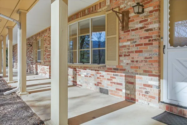 a view of a brick house with a large window