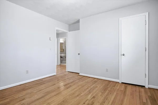 a kitchen with a sink cabinets and wooden floor