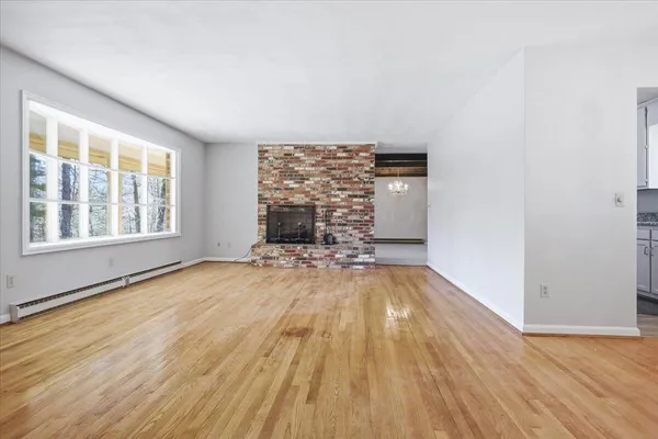 a view of empty room with fireplace and fan