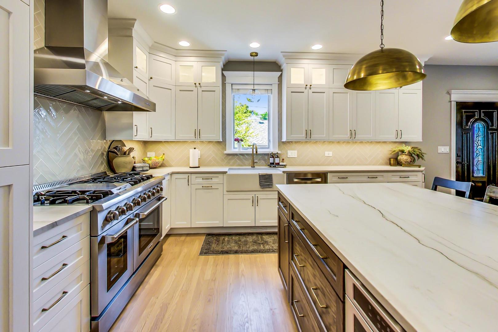 4133 North Kenneth Avenue Chicago, IL 60641 - Photo 14 of 54 a kitchen with a white stove top oven and wooden floor