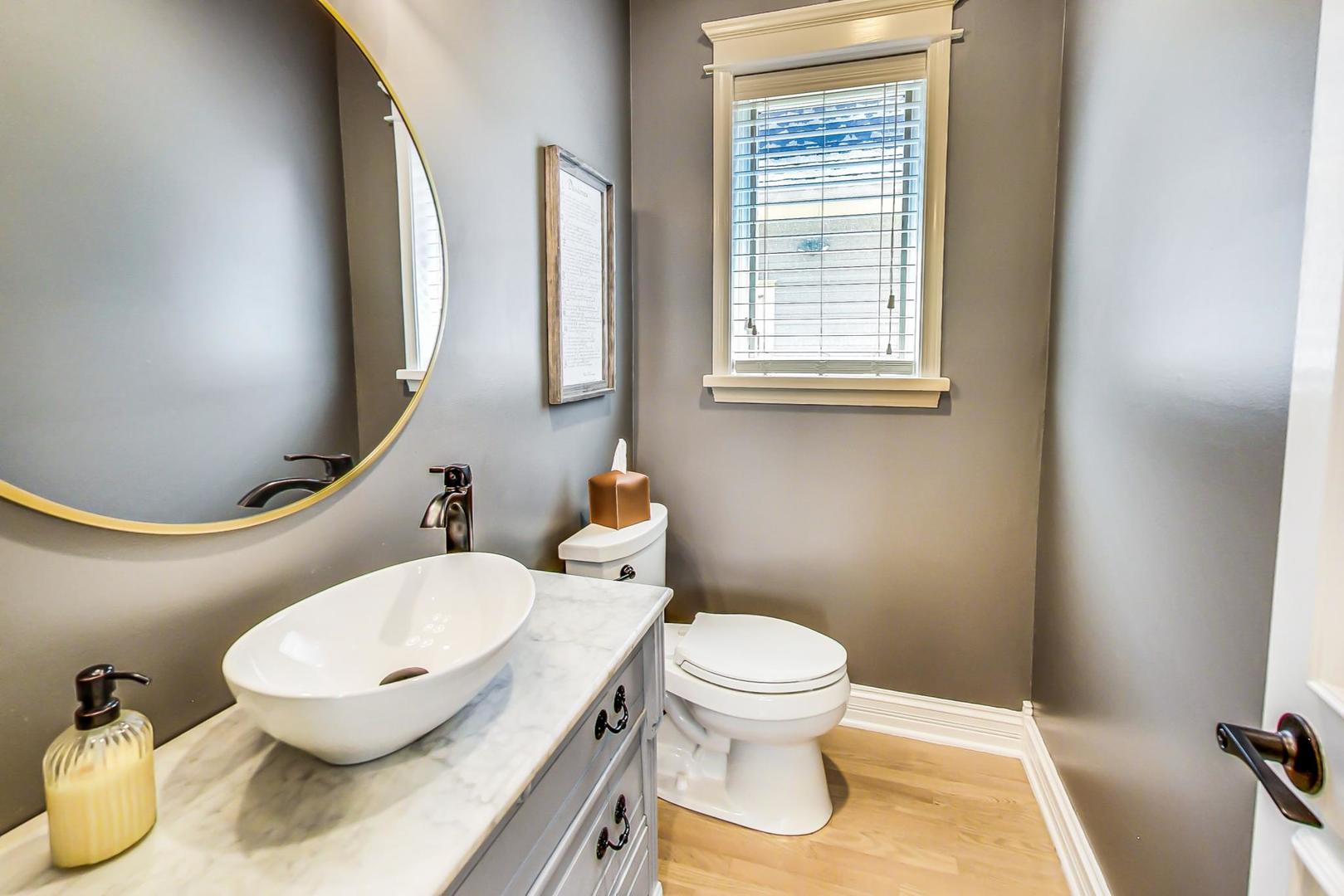 4133 North Kenneth Avenue Chicago, IL 60641 - Photo 17 of 54 a bathroom with a toilet sink and mirror