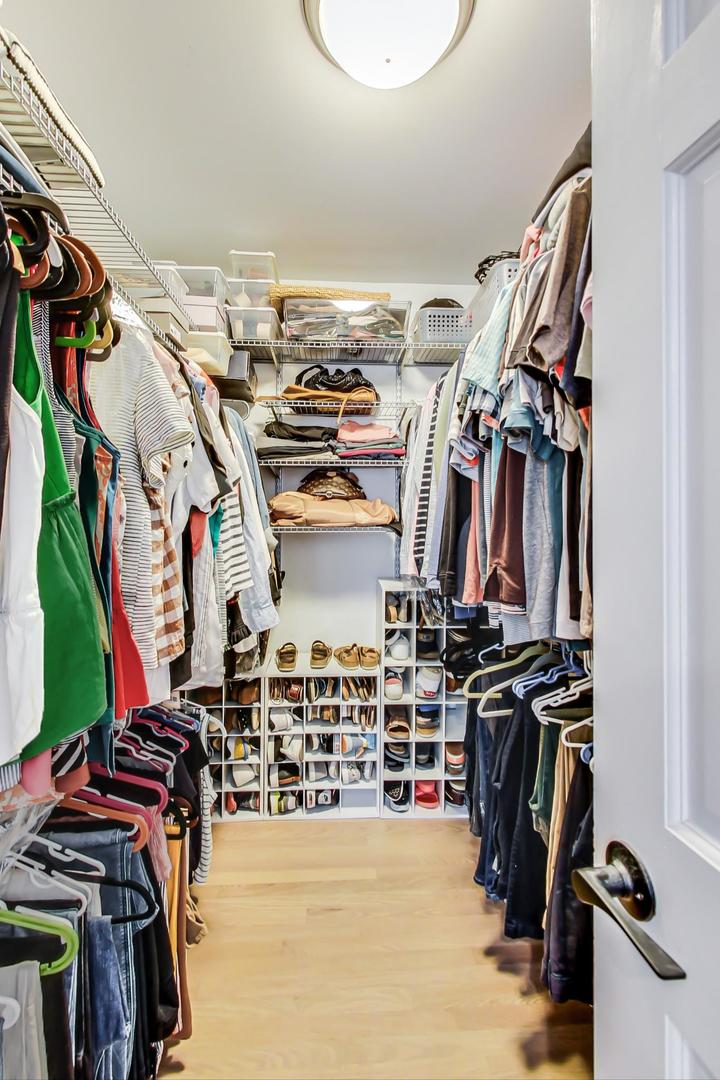 4133 North Kenneth Avenue Chicago, IL 60641 - Photo 22 of 54 a view of walk in closet with clothes and shoes