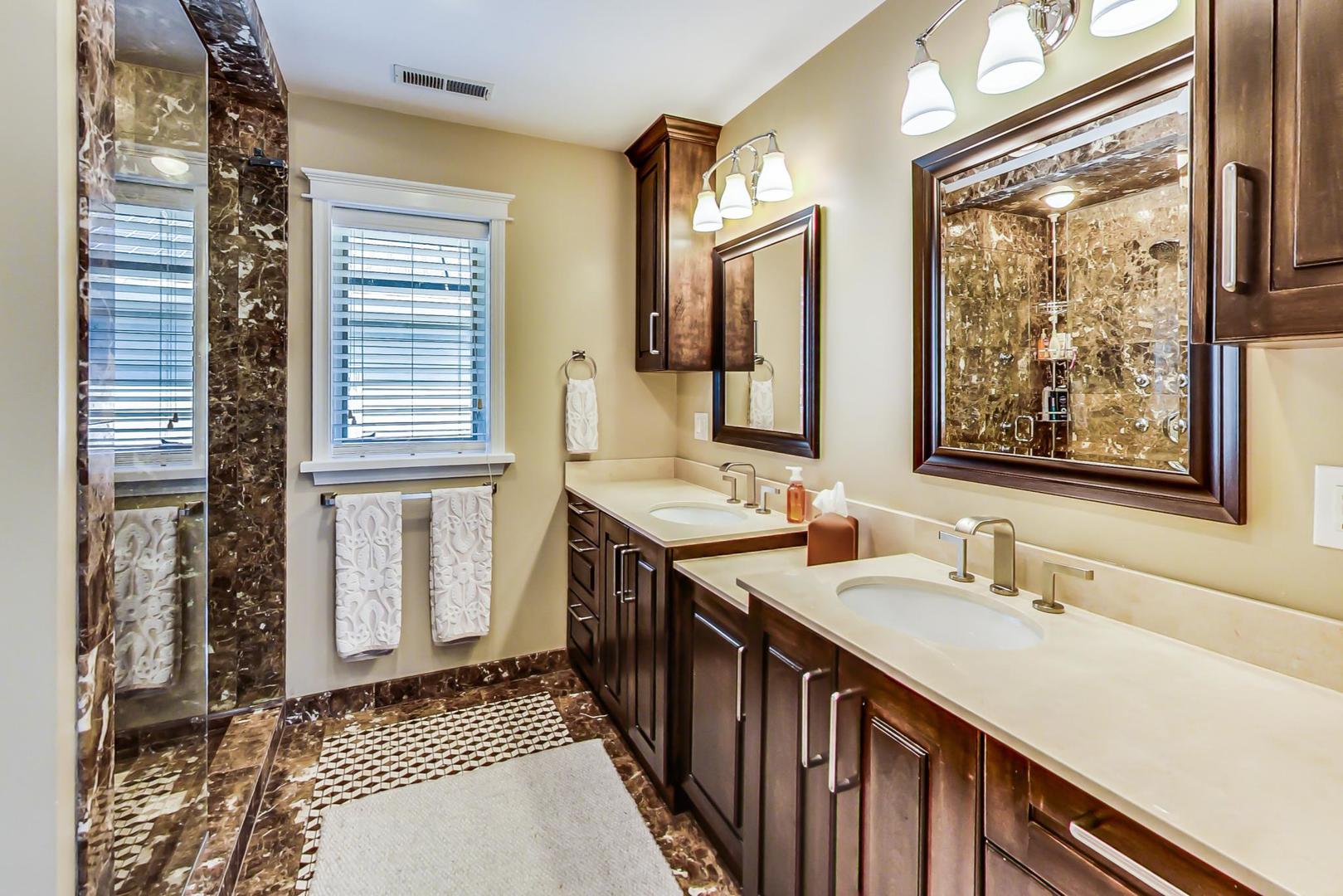 4133 North Kenneth Avenue Chicago, IL 60641 - Photo 23 of 54 a bathroom with double vanity and a mirror