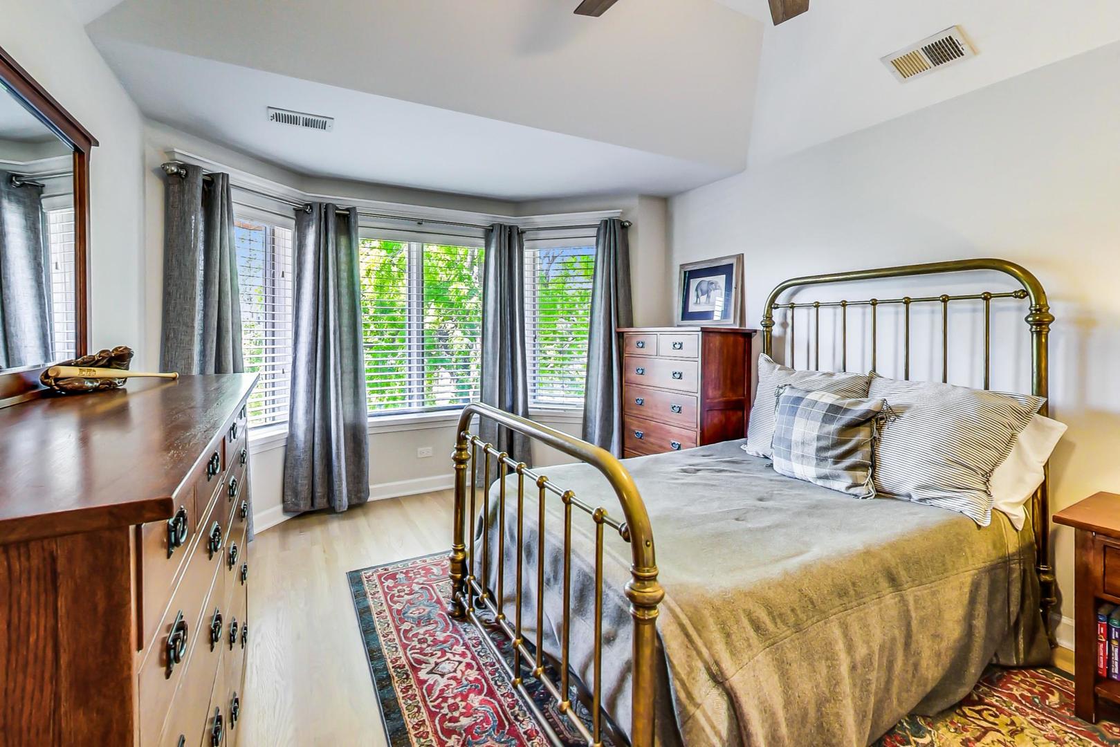 4133 North Kenneth Avenue Chicago, IL 60641 - Photo 29 of 54 a bedroom with a bed next to a large window with the outer view