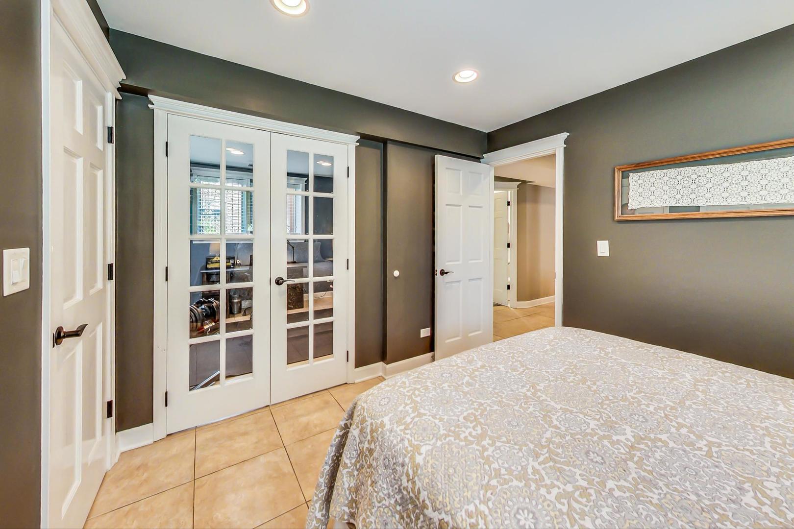 4133 North Kenneth Avenue Chicago, IL 60641 - Photo 37 of 54 a bedroom with a large bed closet and windows