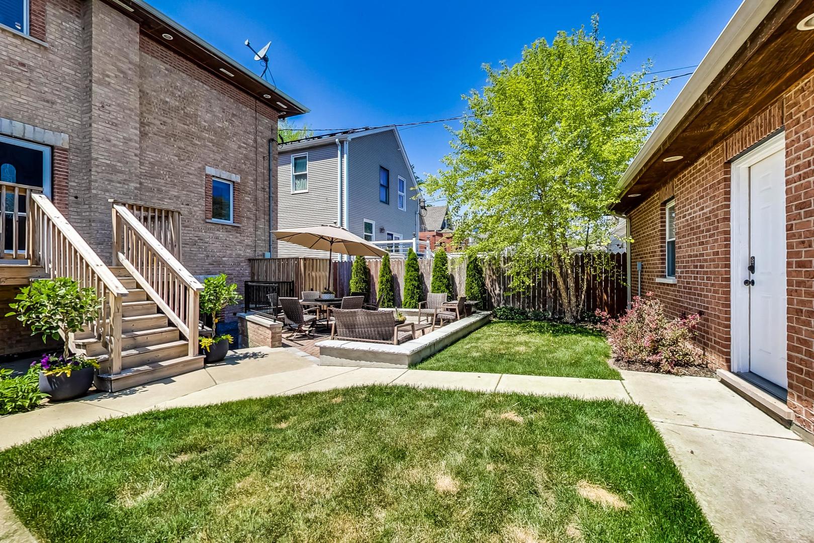 4133 North Kenneth Avenue Chicago, IL 60641 - Photo 46 of 54 a view of a backyard with plants and a patio