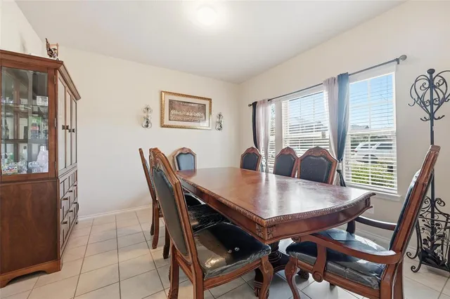 a view of a dining room with furniture and window