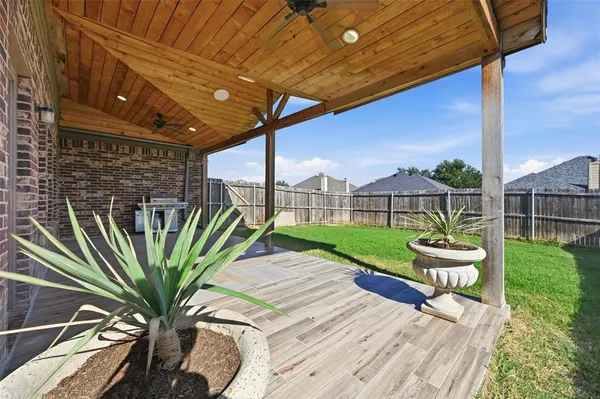 a view of a porch with furniture and garden