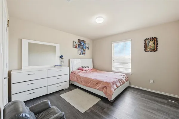 a bedroom with a bed and a dresser