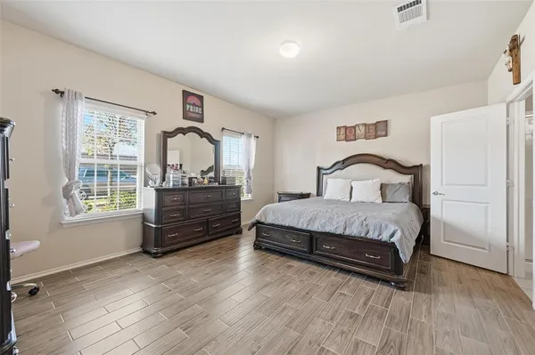 a bedroom with a bed and wooden floor