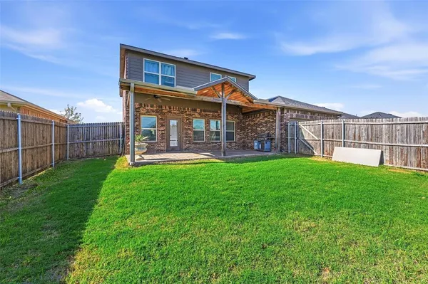 a view of a house with a yard and sitting area
